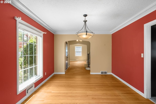 205 NE Billingher Dr, Portland, OR 97220 - unfurnished dining area featuring arched walkways, a healthy amount of sunlight, and visible vents