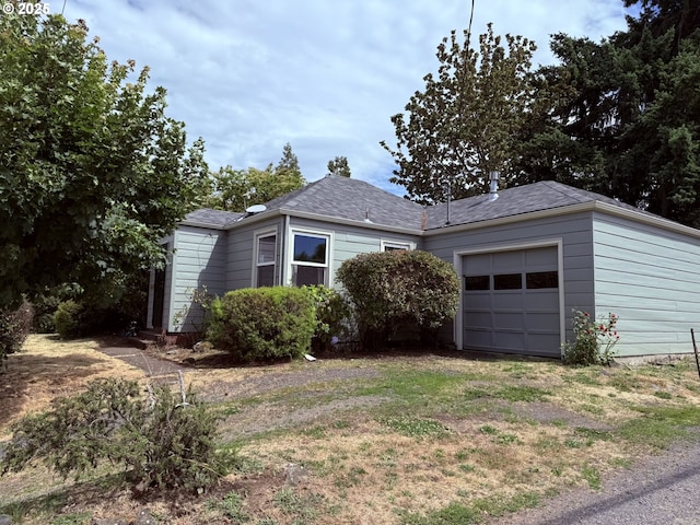 810 W 18th Ave, Eugene, OR 97402 - view of front of house with an attached garage, driveway, and roof with shingles