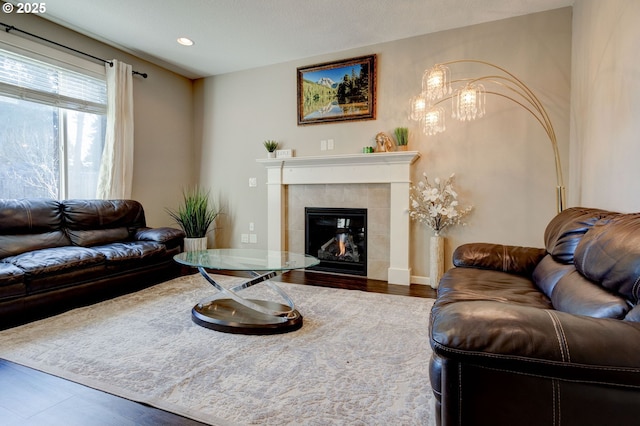 living room featuring dark hardwood / wood-style flooring and a tile fireplace