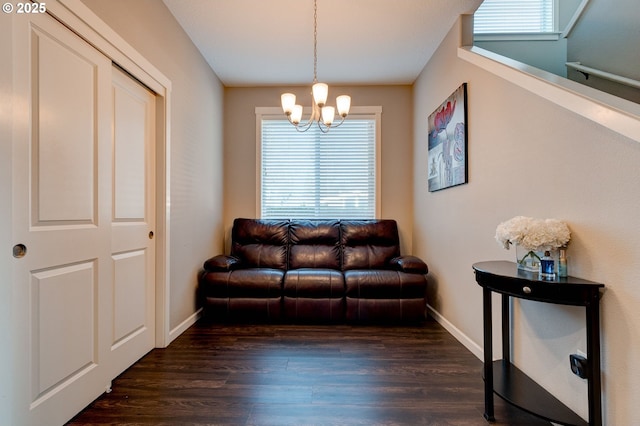 living room featuring dark hardwood / wood-style floors and a chandelier