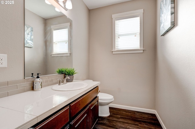 bathroom with vanity, wood-type flooring, and toilet