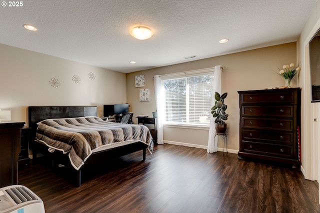 bedroom featuring dark hardwood / wood-style floors and a textured ceiling