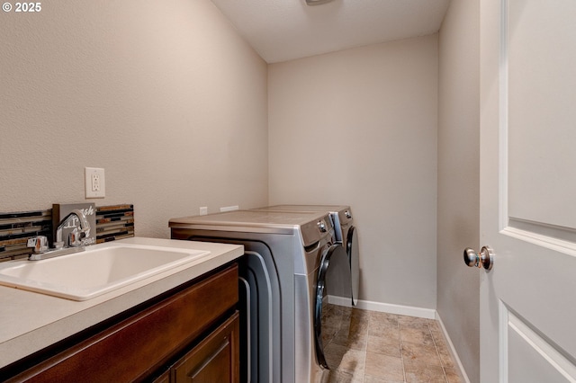 laundry area with sink, cabinets, and washer and dryer