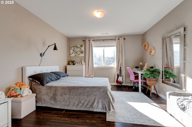 bedroom with dark hardwood / wood-style flooring