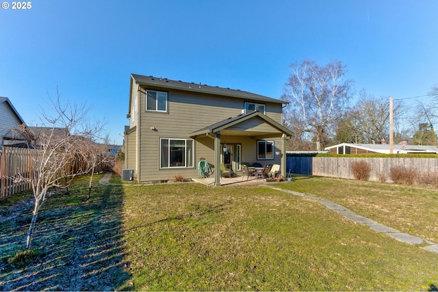 rear view of property featuring a lawn, central air condition unit, and a patio area