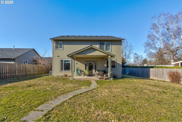 rear view of property with a patio area and a lawn