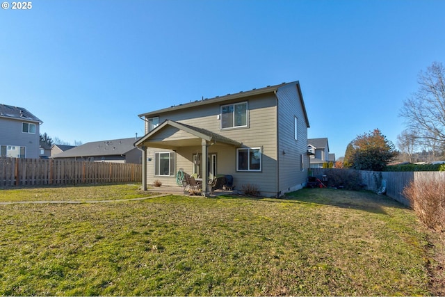 back of property with a yard and a patio area