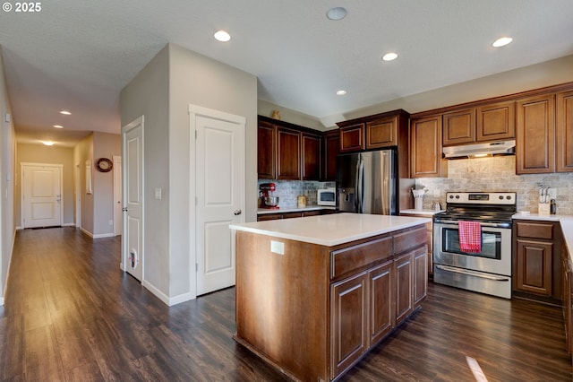 kitchen featuring decorative backsplash, appliances with stainless steel finishes, dark hardwood / wood-style flooring, and a kitchen island