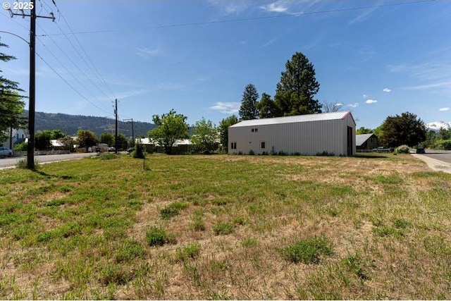 305 N Main St, Halfway, OR 97834 - view of green lawn featuring a pole building and an outdoor structure