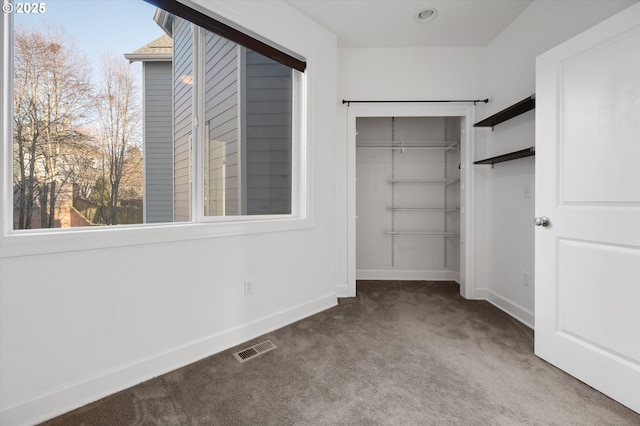 walk in closet featuring carpet flooring