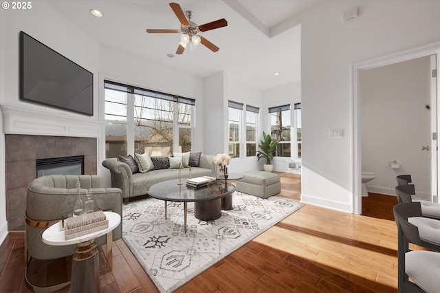 living room with hardwood / wood-style floors, a fireplace, and ceiling fan