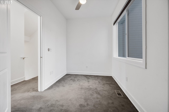 carpeted spare room with ceiling fan