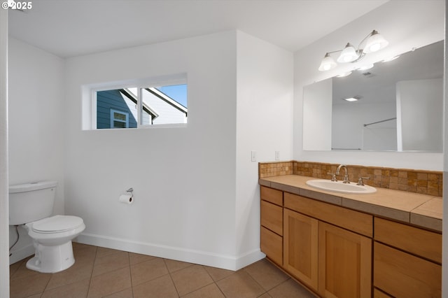 bathroom featuring tasteful backsplash, vanity, toilet, and tile patterned flooring