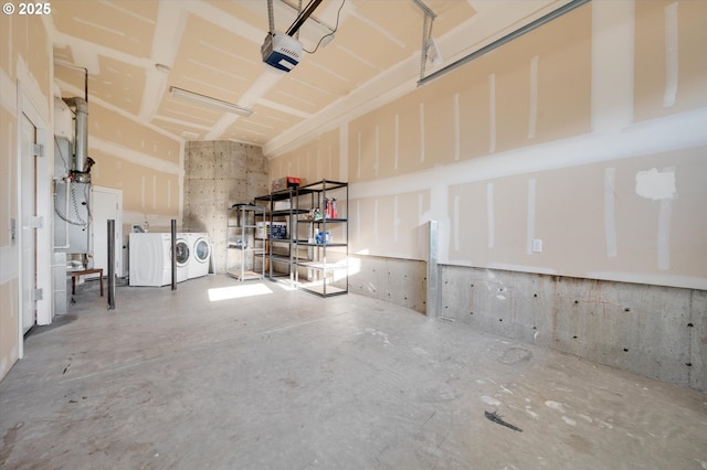 garage with a garage door opener and washer and clothes dryer