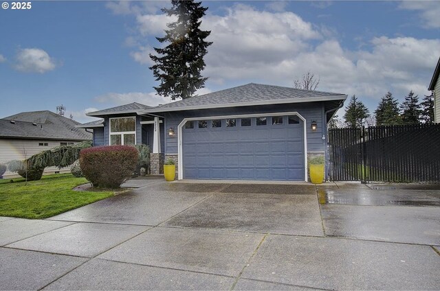 view of front of property with an attached garage, fence, concrete driveway, and roof with shingles