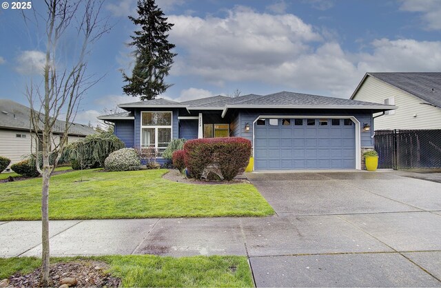 view of front of home featuring concrete driveway, roof with shingles, fence, a front yard, and a garage