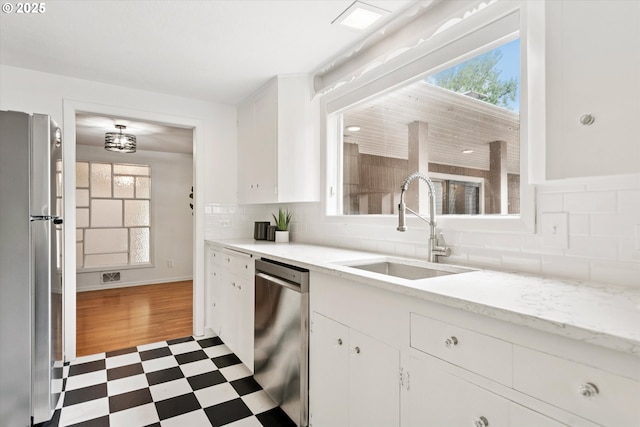 10914 SW 64th Ave, Portland, OR 97219 - kitchen with appliances with stainless steel finishes, dark flooring, plenty of natural light, and white cabinets