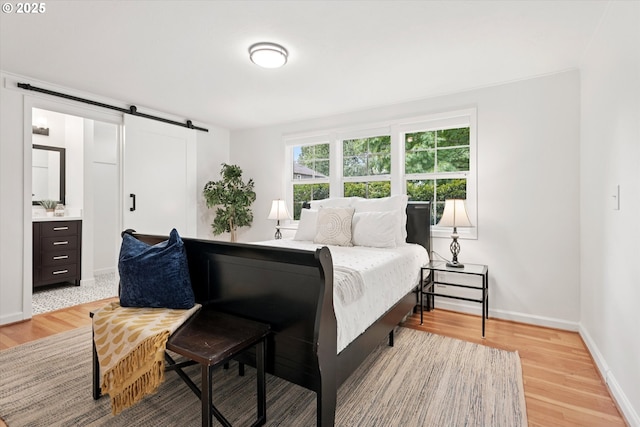 10914 SW 64th Ave, Portland, OR 97219 - bedroom with a barn door and light wood finished floors