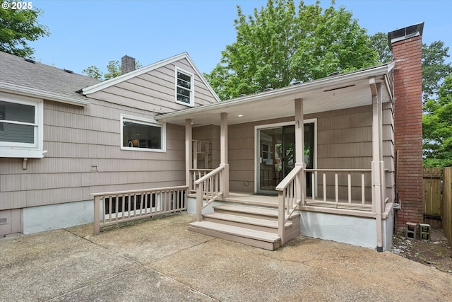 10914 SW 64th Ave, Portland, OR 97219 - view of front of house with a chimney and a patio area