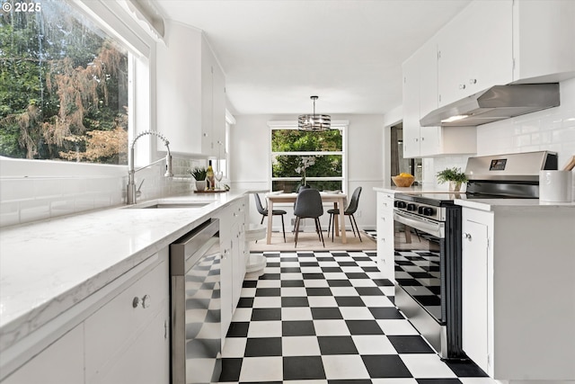10914 SW 64th Ave, Portland, OR 97219 - kitchen featuring stainless steel appliances, under cabinet range hood, white cabinets, dark flooring, and backsplash