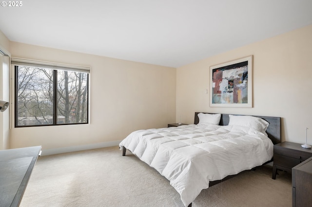 carpeted bedroom featuring baseboards