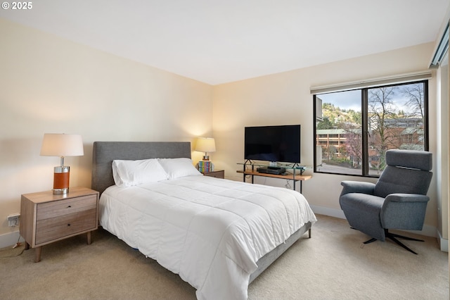 carpeted bedroom featuring baseboards