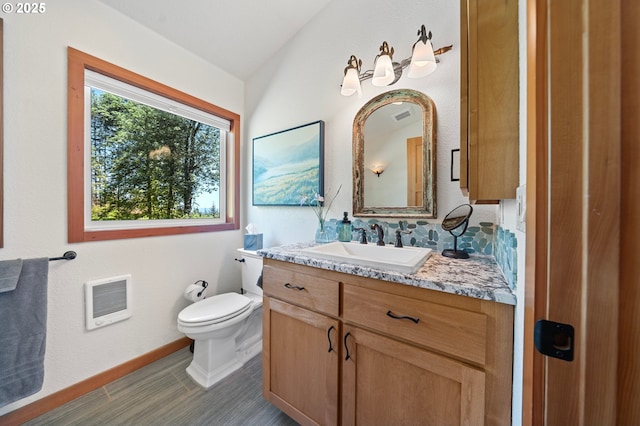 66020 Meissner Rd, Deer Island, OR 97054 - bathroom featuring heating unit, vanity, toilet, and baseboards