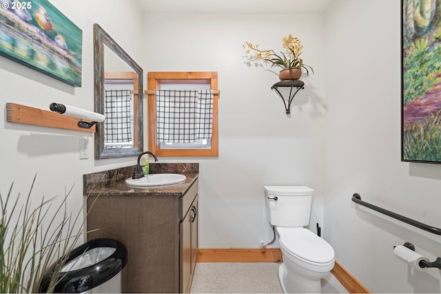 66020 Meissner Rd, Deer Island, OR 97054 - half bath featuring toilet, vanity, baseboards, and speckle patterned floor
