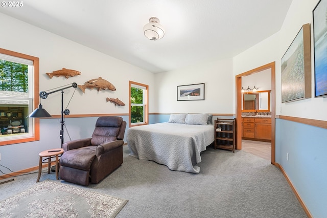 66020 Meissner Rd, Deer Island, OR 97054 - bedroom featuring multiple windows, light carpet, ensuite bath, and baseboards