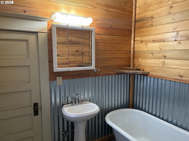 bathroom with a freestanding bath and a sink