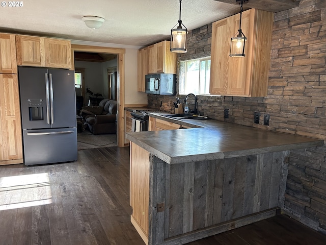 203 SE Alamo St, Enterprise, OR 97828 - kitchen featuring stainless steel fridge, gas range, plenty of natural light, dark wood-style floors, and a textured ceiling