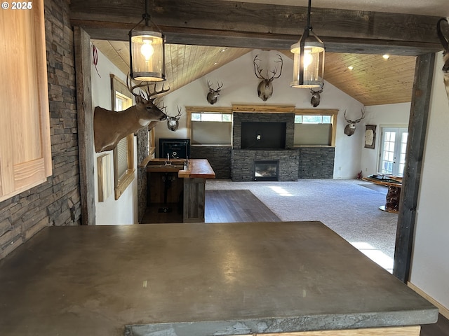 unfurnished living room with a fireplace and wood ceiling