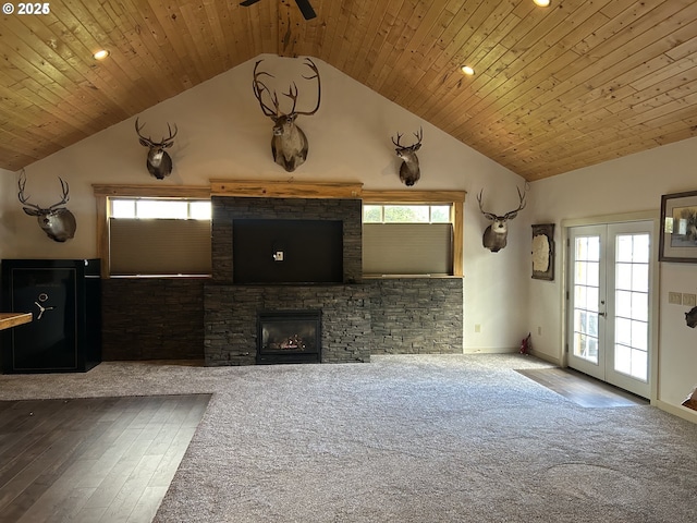 203 SE Alamo St, Enterprise, OR 97828 - unfurnished living room featuring lofted ceiling, wood finished floors, a ceiling fan, wood ceiling, and a stone fireplace