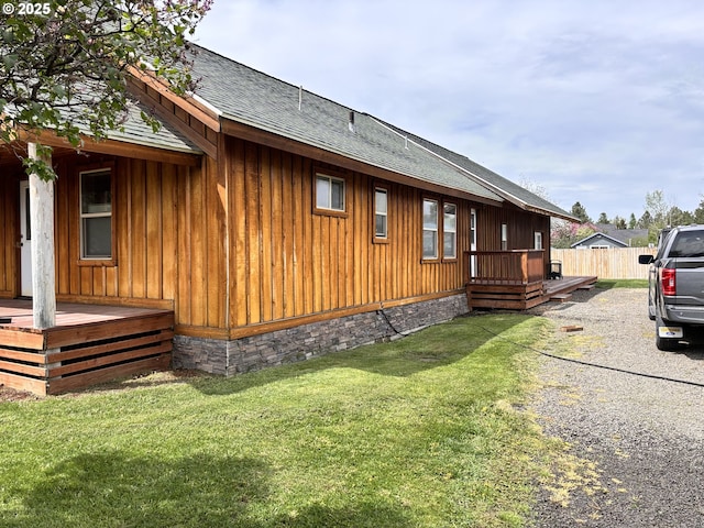 203 SE Alamo St, Enterprise, OR 97828 - view of home's exterior with board and batten siding, roof with shingles, and a lawn