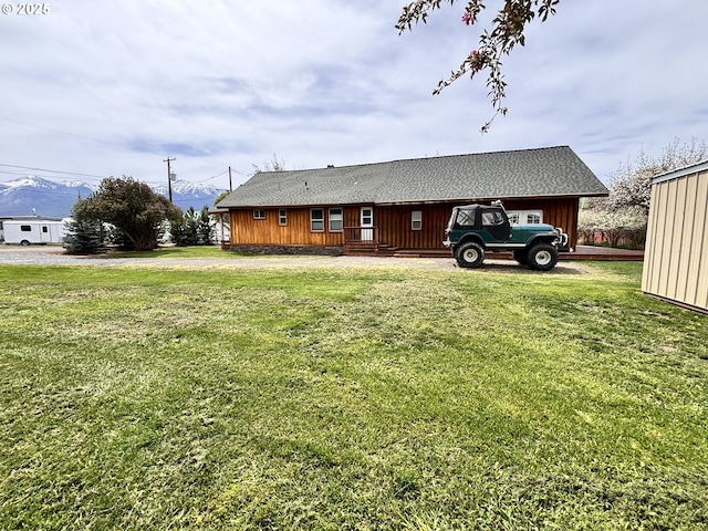 view of side of property with a yard