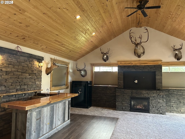 kitchen featuring vaulted ceiling, healthy amount of natural light, hardwood / wood-style flooring, wood ceiling, and a ceiling fan