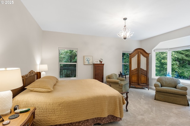 bedroom featuring a notable chandelier and light colored carpet