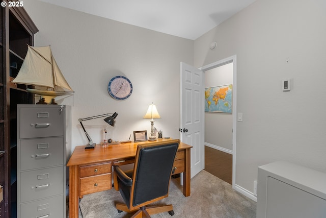 office area featuring baseboards and carpet