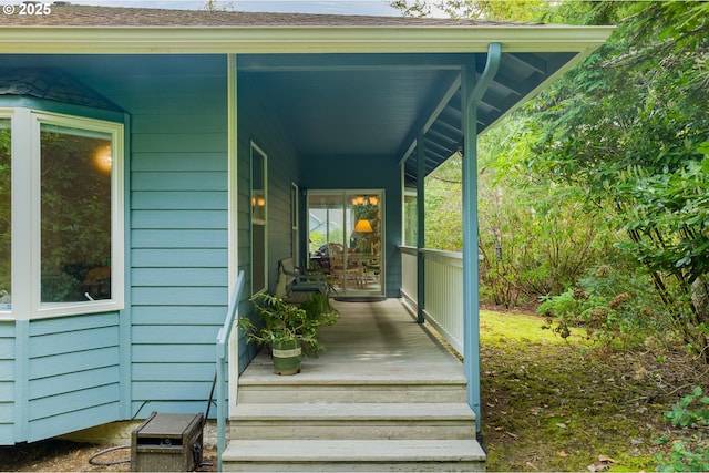 view of exterior entry featuring covered porch