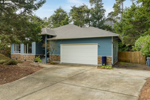 view of front of home with stone siding, fence, roof with shingles, concrete driveway, and a garage