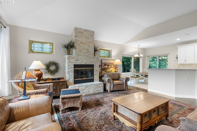 living room featuring a notable chandelier, a fireplace, and vaulted ceiling