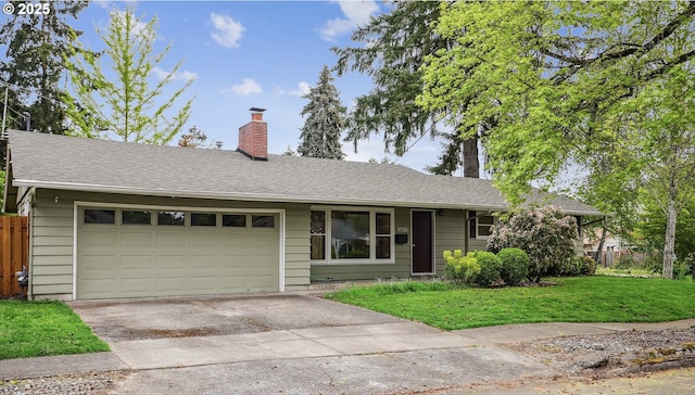 ranch-style home featuring driveway, a chimney, a front yard, fence, and an attached garage