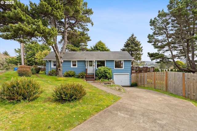 ranch-style house featuring a garage, a front yard, driveway, and fence