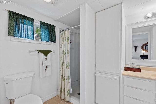bathroom with a shower stall, tile patterned floors, vanity, and toilet