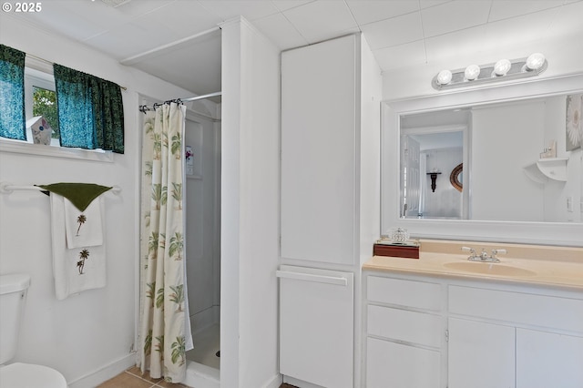 bathroom with tile patterned flooring, toilet, a shower stall, and vanity
