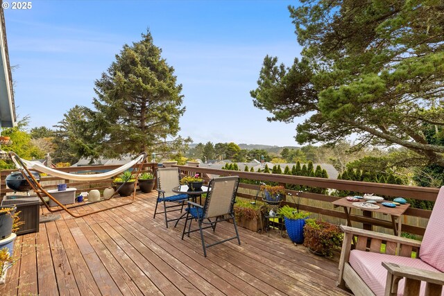 wooden deck featuring outdoor dining area