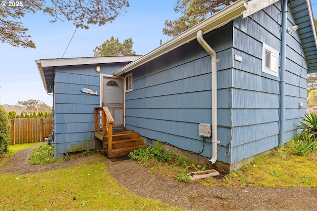 view of home's exterior featuring fence