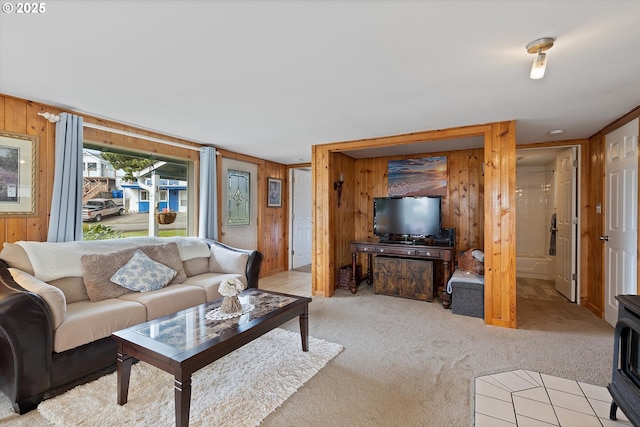 living room with wooden walls and light carpet