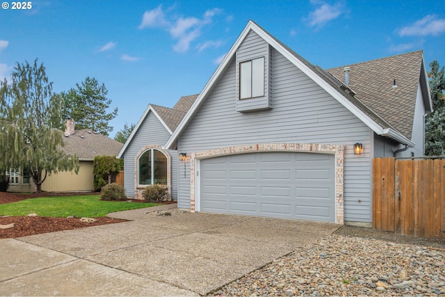 view of front of property featuring driveway, a shingled roof, and fence