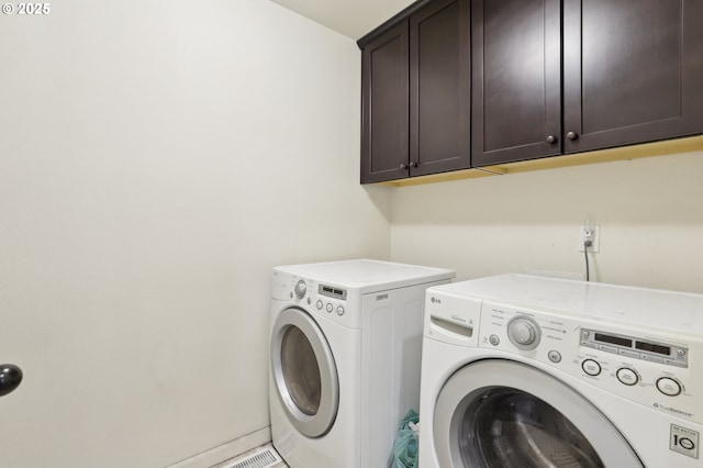 laundry area with washer and clothes dryer and cabinet space